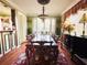 Elegant dining room featuring hardwood floors, a large wooden table, and abundant natural light at 2015 E Beacon By Way, Lakeland, FL 33803