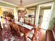 Traditional dining room featuring hardwood floors, a floral rug, carved wood table, and views into kitchen at 2015 E Beacon By Way, Lakeland, FL 33803