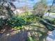 Well maintained front yard with mature trees, landscaping and partial view of the lake at 2015 E Beacon By Way, Lakeland, FL 33803