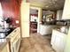 Bright kitchen with custom cabinets, granite countertops, tile floors and view through to dining room at 2015 E Beacon By Way, Lakeland, FL 33803