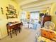 Bright living room featuring yellow walls, white beamed ceiling, and cozy seating with a blue and white color scheme at 2015 E Beacon By Way, Lakeland, FL 33803