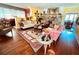 Well-lit living room with hardwood floors and an open layout leading to the dining area at 2015 E Beacon By Way, Lakeland, FL 33803