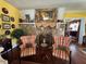 Cozy living room featuring a stone fireplace and two comfortable plaid armchairs at 2015 E Beacon By Way, Lakeland, FL 33803