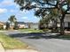 Scenic street view with mature trees, landscaping and view of the lake at 2015 E Beacon By Way, Lakeland, FL 33803