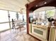 Bright sunroom featuring a glass top table and seating, accented by a chandelier and tile floors at 2015 E Beacon By Way, Lakeland, FL 33803