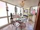 Sunlit sunroom with a decorative glass table, chandelier, and large windows providing abundant natural light at 2015 E Beacon By Way, Lakeland, FL 33803