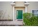 Charming entrance with a bright green door surrounded by lush landscaping at 2038 Winterset Dr # 2038, Lakeland, FL 33813