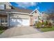 Home exterior showcasing a two-car garage, driveway, and manicured landscaping at 2038 Winterset Dr # 2038, Lakeland, FL 33813