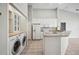 Kitchen with white cabinetry and appliances adjacent to laundry area, maximizing convenience at 2038 Winterset Dr # 2038, Lakeland, FL 33813