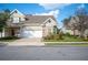 Charming two-story townhome with stone accents, attached garage, and well-maintained landscaping on a sunny day at 2038 Winterset Dr # 2038, Lakeland, FL 33813