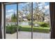 Expansive views of the backyard, lake, and moss-draped tree seen through sliding glass doors at 2038 Winterset Dr # 2038, Lakeland, FL 33813