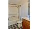 Bathroom features shower-tub combination, wood vanity, and patterned tile floor at 209 Ann Ave, Dundee, FL 33838