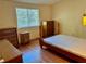 Bedroom features wood laminate floors, a window, and space for sleeping at 209 Ann Ave, Dundee, FL 33838