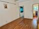 Wood laminate flooring in the bedroom with views to the adjoining rooms and doorway at 209 Ann Ave, Dundee, FL 33838