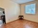 Bright bedroom with wood floors and natural light from the window at 209 Ann Ave, Dundee, FL 33838