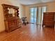 Spacious bedroom with wood laminate flooring, sliding glass doors, and vintage dresser set at 209 Ann Ave, Dundee, FL 33838