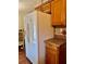 The refrigerator in the kitchen is large and white with a water dispenser on the front. Wood cabinets and laminate counter at 209 Ann Ave, Dundee, FL 33838