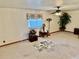 Neutral living room with carpet, window, and ceiling fan at 209 Ann Ave, Dundee, FL 33838