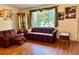 Comfortable living room featuring hardwood floors, a large window, and classic furnishings at 209 Ann Ave, Dundee, FL 33838