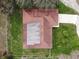 Aerial view of a well-maintained home featuring a red roof and surrounding greenery at 2111 Groveglen S Ln, Lakeland, FL 33813