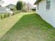 Spacious backyard with lush green grass, bordered by a chain-link fence and neat landscaping at 2111 Groveglen S Ln, Lakeland, FL 33813