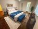 Nicely staged main bedroom with soft carpet, bright light and ensuite bathroom at 2111 Groveglen S Ln, Lakeland, FL 33813