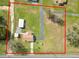 Aerial view showcasing the property's boundaries, outbuildings, and surrounding landscape at 2305 State Road 33 Hwy, Clermont, FL 34714