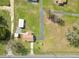 Aerial view featuring a home with a large yard and sheds on a spacious lot at 2305 State Road 33 Hwy, Clermont, FL 34714