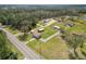 An aerial view of a residential property featuring a home, outbuildings, and surrounding greenery at 2305 State Road 33 Hwy, Clermont, FL 34714