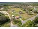 Aerial view capturing the home, sheds, and expansive yard, showcasing the property's layout at 2305 State Road 33 Hwy, Clermont, FL 34714