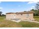 A cozy backyard featuring an exterior door and a small gravel patio at 2305 State Road 33 Hwy, Clermont, FL 34714