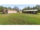 Large backyard featuring a shed and storage area, lawn, and exterior of the home at 2305 State Road 33 Hwy, Clermont, FL 34714