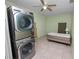 Bedroom featuring a ceiling fan, bed and stacked washer/dryer at 2305 State Road 33 Hwy, Clermont, FL 34714