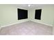 Bedroom featuring neutral walls and black curtains on the windows at 2305 State Road 33 Hwy, Clermont, FL 34714