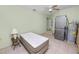 Bedroom featuring a ceiling fan, washer/dryer, bed and side table with lamp at 2305 State Road 33 Hwy, Clermont, FL 34714