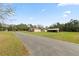 Charming single-Gathering home with a long driveway and large, open front yard at 2305 State Road 33 Hwy, Clermont, FL 34714