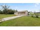 Exterior view of the home with a well-maintained front yard, driveway, and charming curb appeal at 2305 State Road 33 Hwy, Clermont, FL 34714