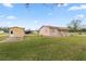 Exterior view of a home with a shed, well-maintained lawn, and a serene atmosphere at 2305 State Road 33 Hwy, Clermont, FL 34714