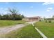 Spacious front yard with a shed, lush lawn, and a single-story home at 2305 State Road 33 Hwy, Clermont, FL 34714