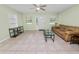 Inviting living room with tile floors, neutral walls, and a comfortable couch, perfect for relaxing and entertaining at 2305 State Road 33 Hwy, Clermont, FL 34714