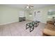 Spacious living room featuring tile floors, a ceiling fan, and natural light, ideal for comfortable living and relaxation at 2305 State Road 33 Hwy, Clermont, FL 34714