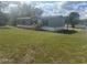 Well-maintained manufactured home with a lush green lawn at 2403 Gerties Rd, Bartow, FL 33830