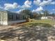 Charming manufactured home featuring a large front yard and a freshly graveled drive at 2403 Gerties Rd, Bartow, FL 33830