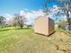 View of the backyard featuring a storage shed and mature trees at 2532 Everleth Dr, Lakeland, FL 33810