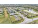 Wide aerial shot of a gated community featuring well-kept homes, green spaces, and serene pond views at 2917 Blackwater Creek Dr, Lakeland, FL 33810