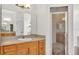 Bathroom featuring a wood vanity with countertop sink and a glass-enclosed shower at 2917 Blackwater Creek Dr, Lakeland, FL 33810