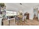 Bright dining room featuring wood-look floors, neutral paint, and sliding glass doors to the backyard at 2917 Blackwater Creek Dr, Lakeland, FL 33810