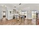 Bright dining room featuring wood-look floors, neutral paint, and sliding glass doors to the backyard at 2917 Blackwater Creek Dr, Lakeland, FL 33810