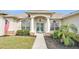 Inviting home with a beautiful walkway leading to an arched entryway and double doors at 2917 Blackwater Creek Dr, Lakeland, FL 33810