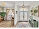 Foyer featuring a chandelier, decorative doors, wood-look floors, and neutral paint at 2917 Blackwater Creek Dr, Lakeland, FL 33810